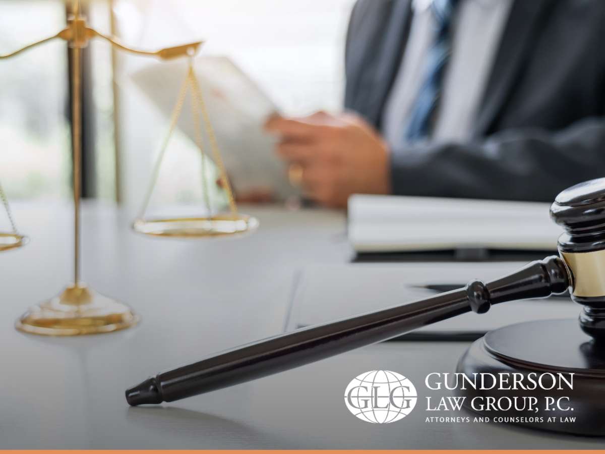 Lawyer reviewing documents beside gavel and scales of justice, discussing a child's inheritance 