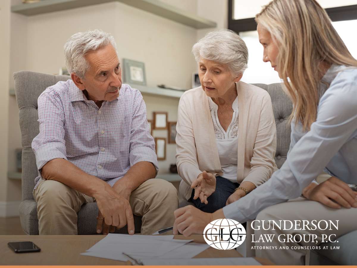 Estate planning attorney signing legal documents with gavel nearby.